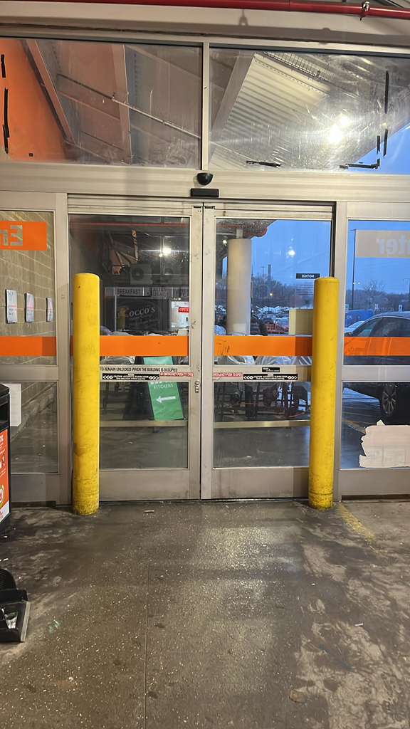 Damaged storefront transom glass before emergency repair